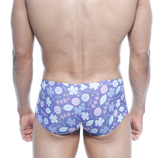 Purple floral swim trunks with light pink and white blossoms and green leaves on soft stretchy fabric by MetroMaleWear