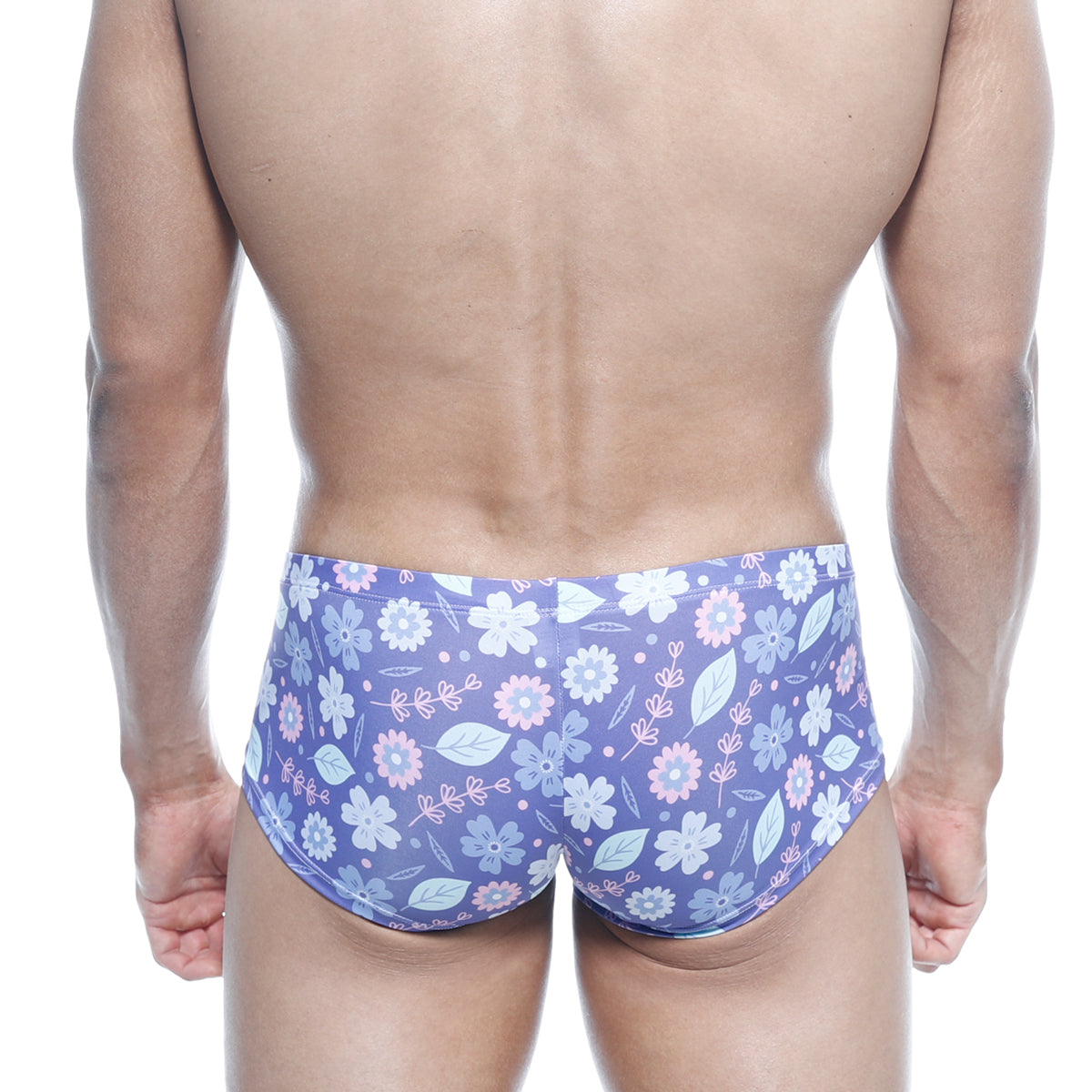 Purple floral swim trunks with light pink and white blossoms and green leaves on soft stretchy fabric by MetroMaleWear