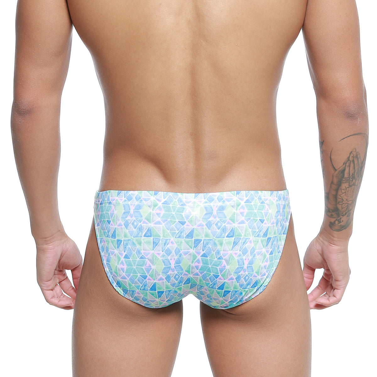 A man wearing metro malewear classic swim bikini glass 4937-62 swim trunks with blue green and white geometric pattern