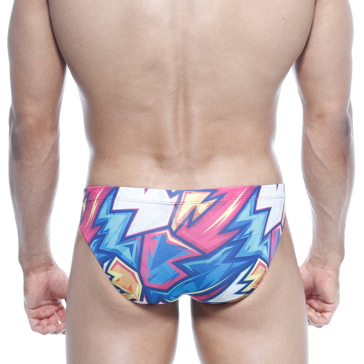 MetroMalewear Vasco hip brief swim trunks with vibrant pink blue and yellow lightning bolt graffiti pattern on white base