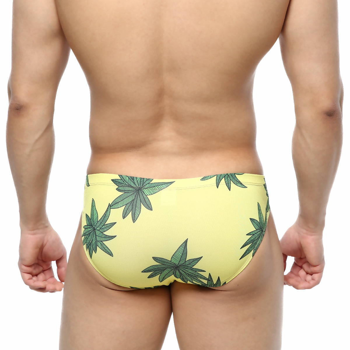 Yellow swim trunks by metromalewear featuring bold green cannabis leaf pattern for casual beachwear use