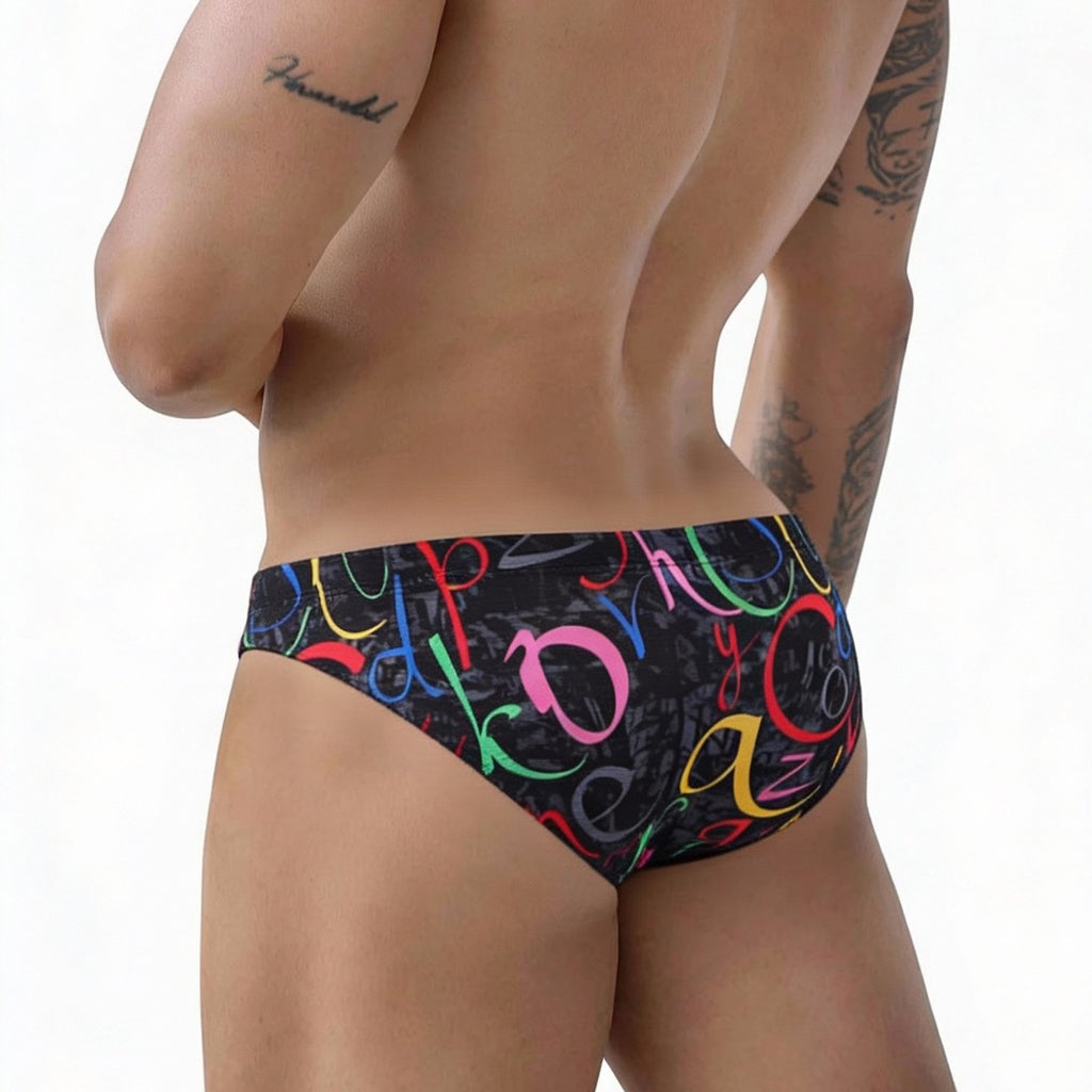 Black swim trunks metroMalewear pinaculo bikini 5103-m85 with vibrant multicolored graffiti-style lettering pattern