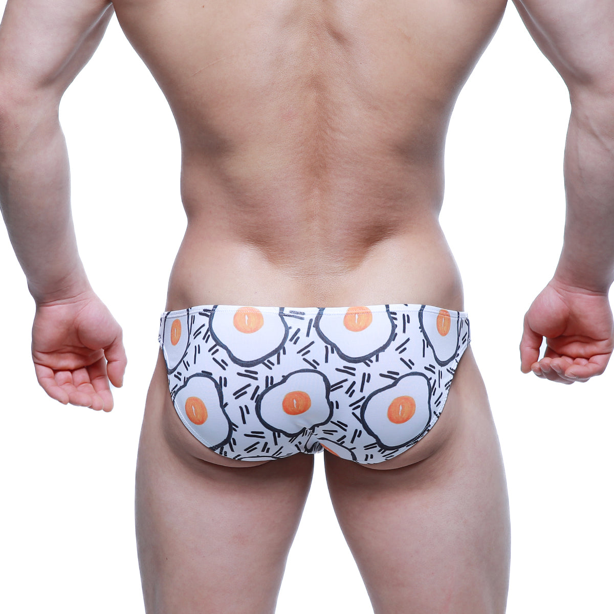 White swim trunks by MetroMaleWear with cartoon fried egg pattern and black line accents lowrise bikini 6115-67