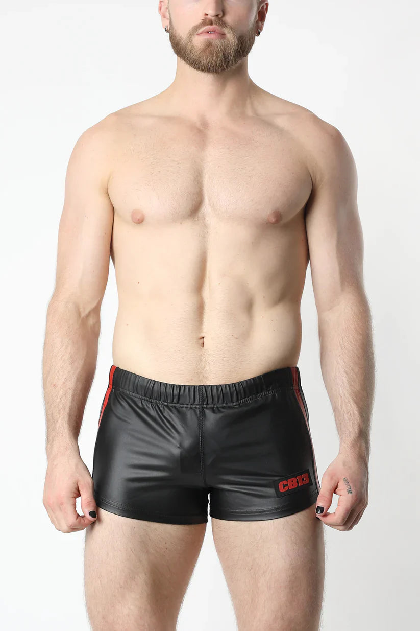 Black shiny faux leather anti-chrome gear shorts with red side stripes and embroidered logo on the left leg
