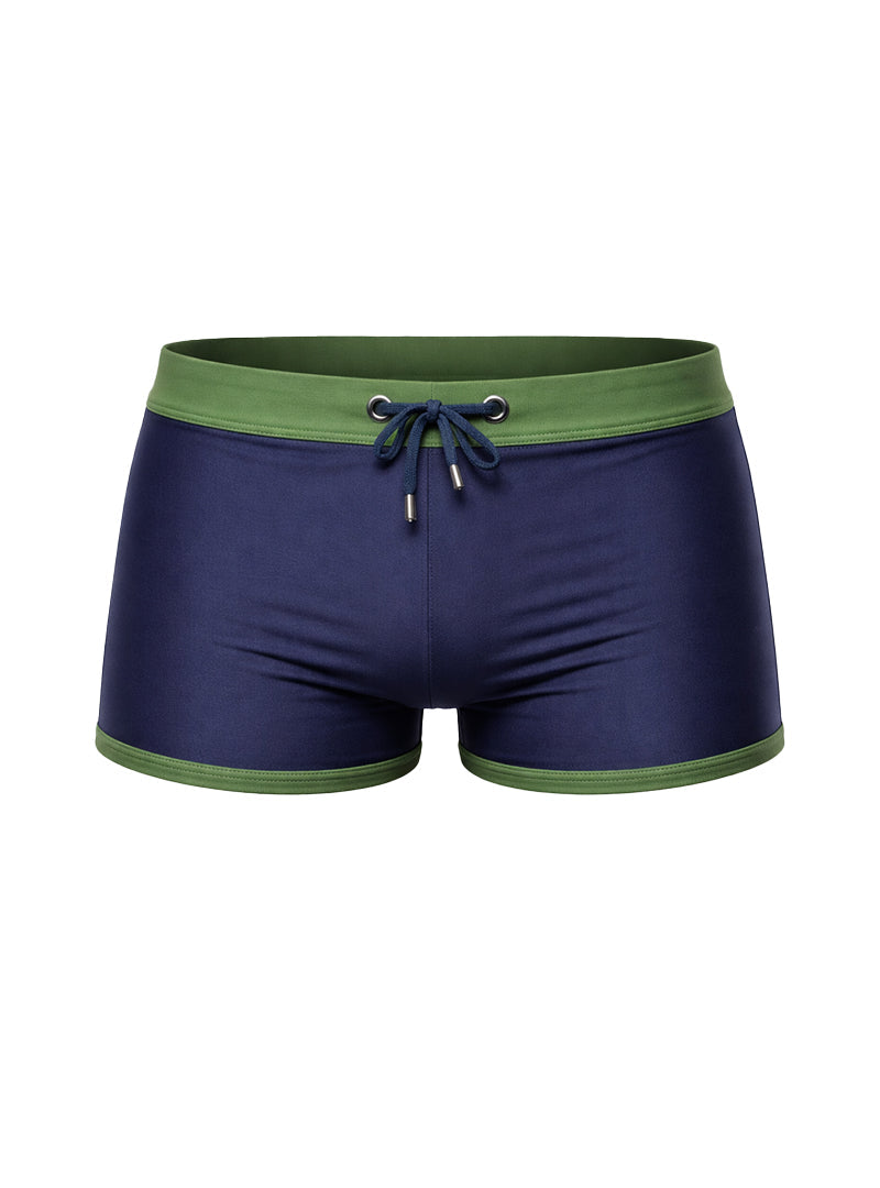 Navy blue square trunk with green waistband and drawstring made of stretchy material by Kineo.