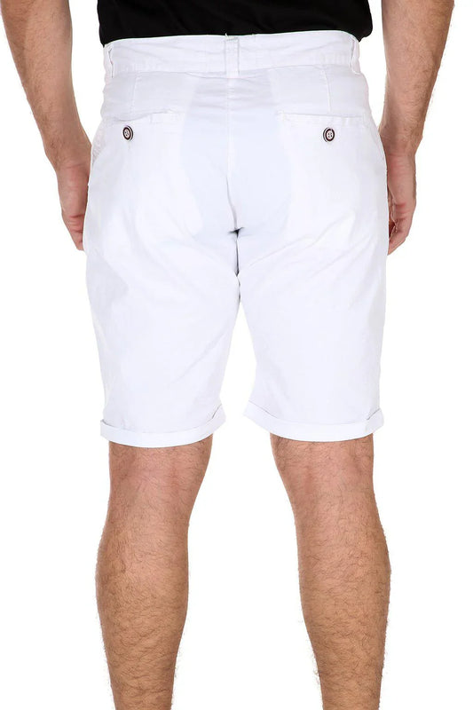 Rear view of a person wearing white cotton shorts with cuffed hems and buttoned back pockets.