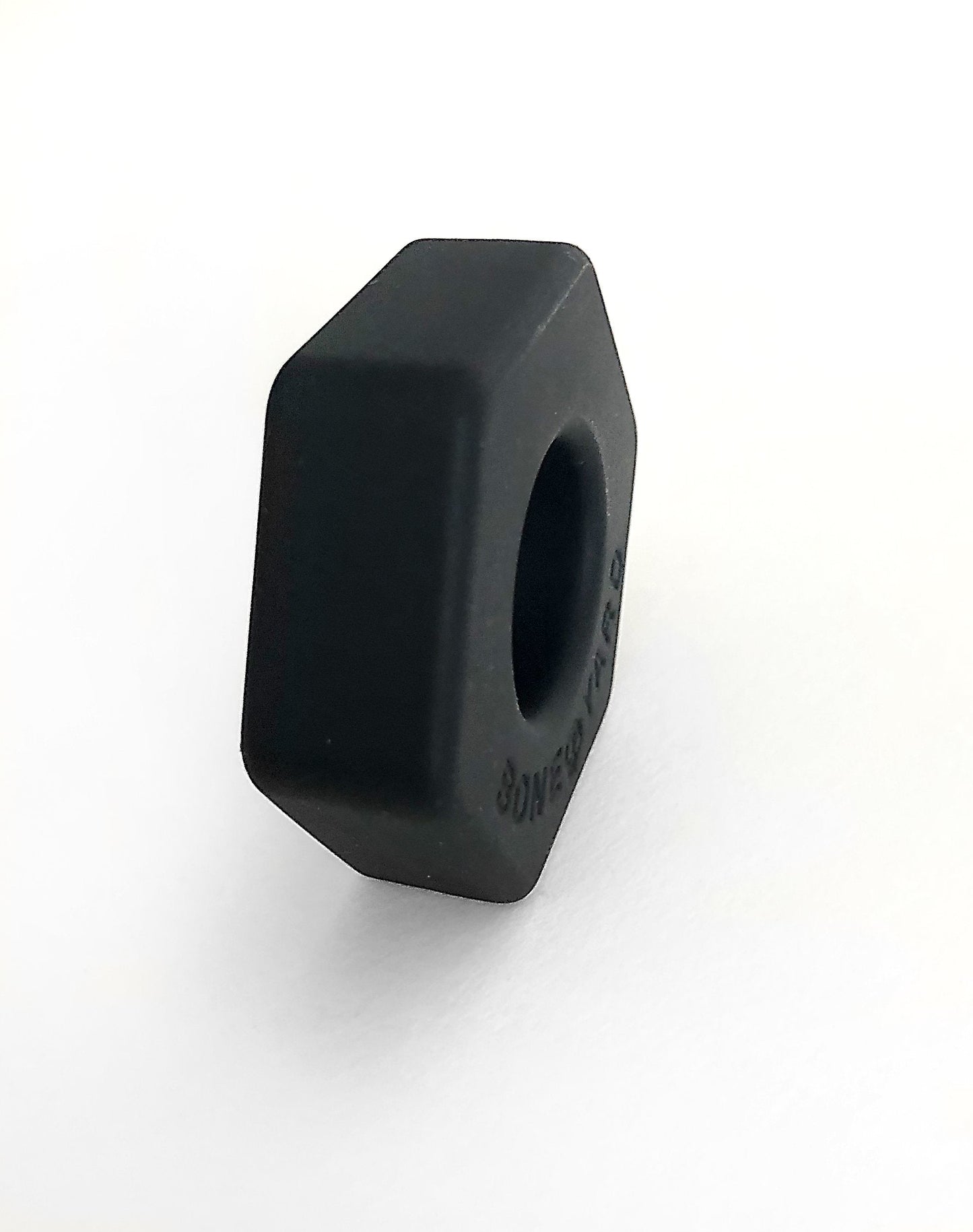 Black hexagonal nut with matte finish and engraved text on the side from bust a nut black product line