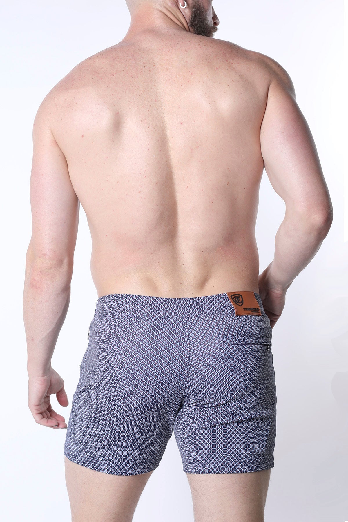 Clemente swim short limited edition blue patterned swim trunks with subtle geometric design and brown leather waistband patch