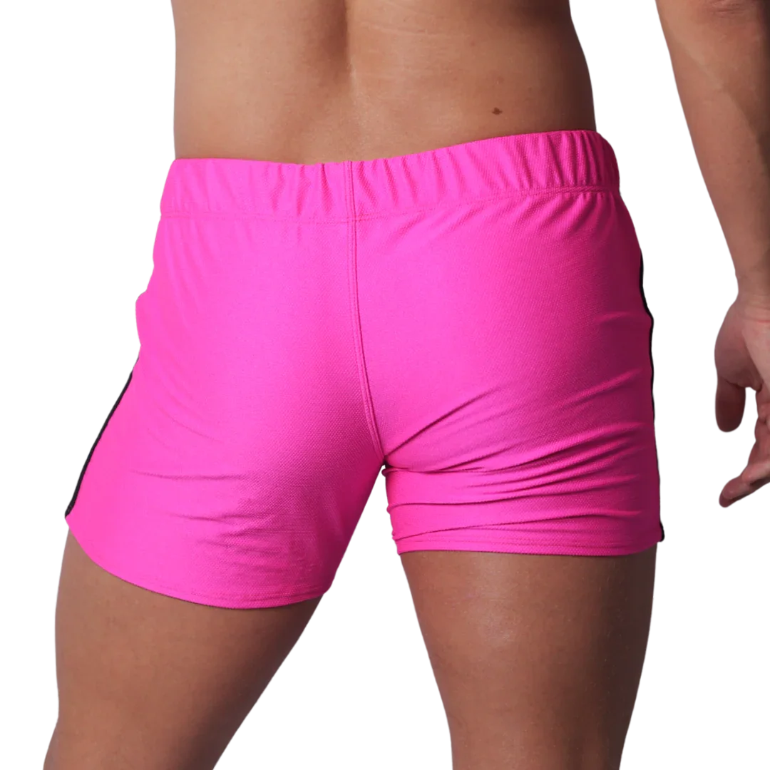 Fuchsia athletic short-shorts in a textured performance fabric with an elastic waistband, viewed from the back.
