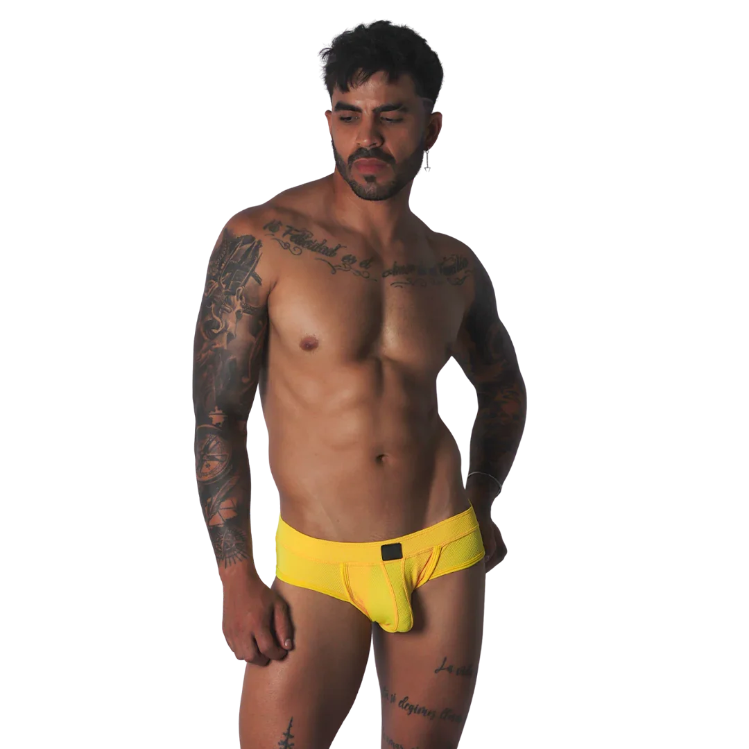 Bright yellow mesh low-rise brief with a centered rectangular black logo patch.