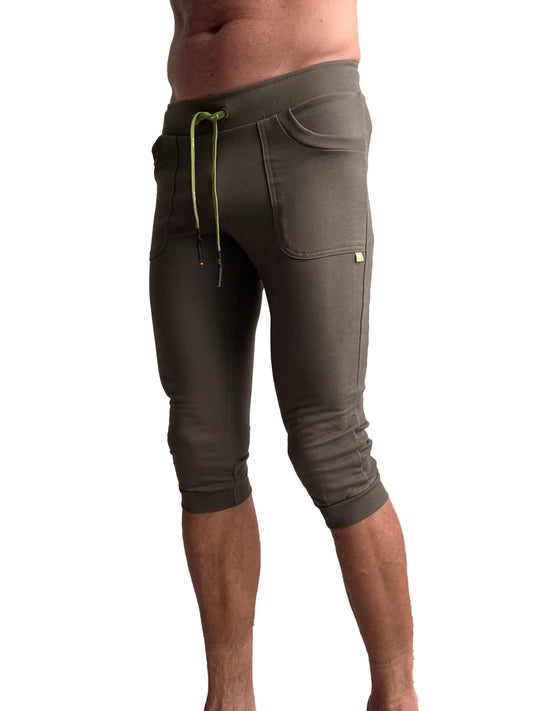 Olive green cuffed yoga pants with ribbed waistband and lime green drawstring in capri-length jogger style