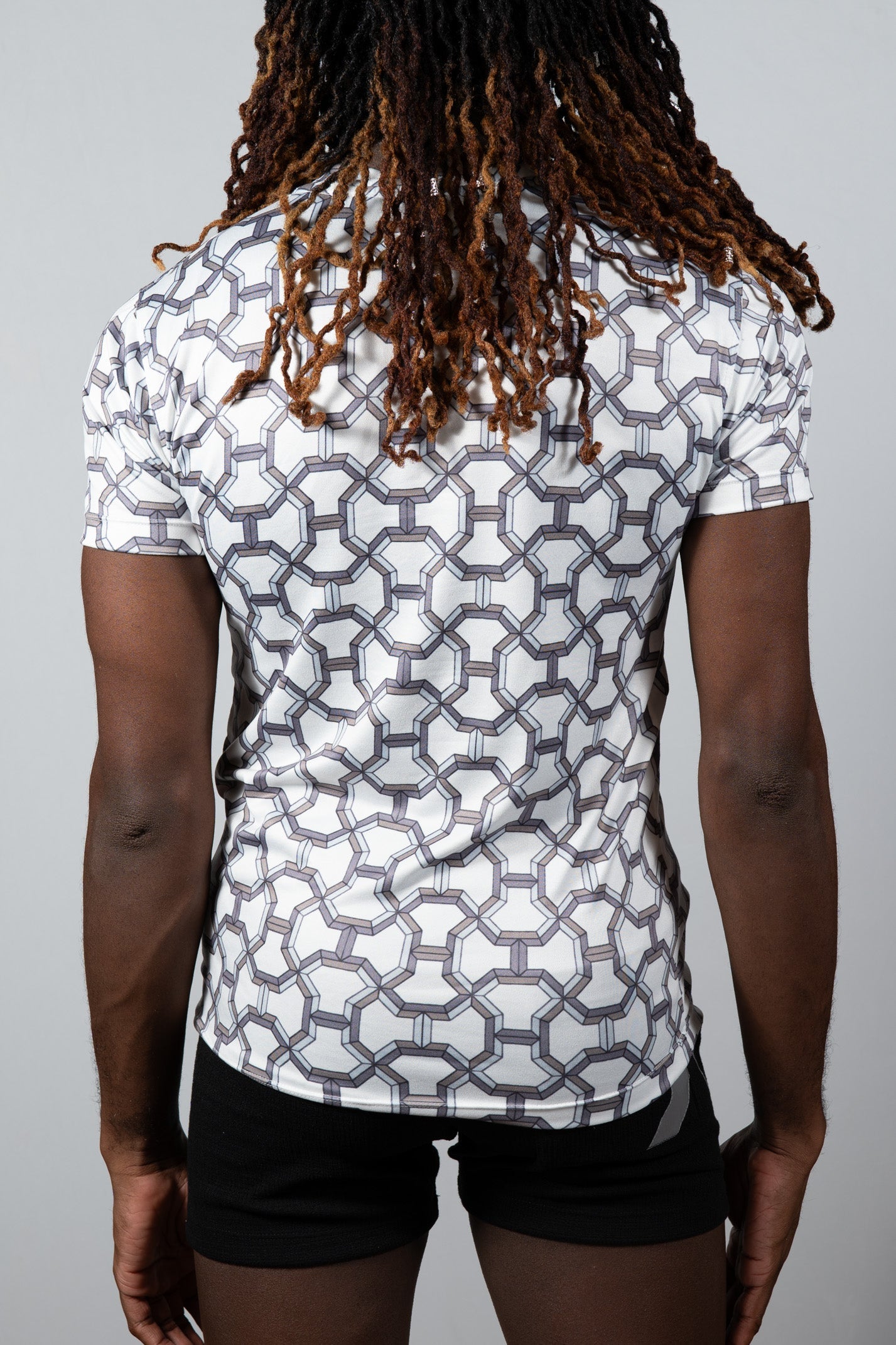 White short-sleeved athletic shirt with a geometric gray pattern designed for activewear in the designer inspired print tee collection