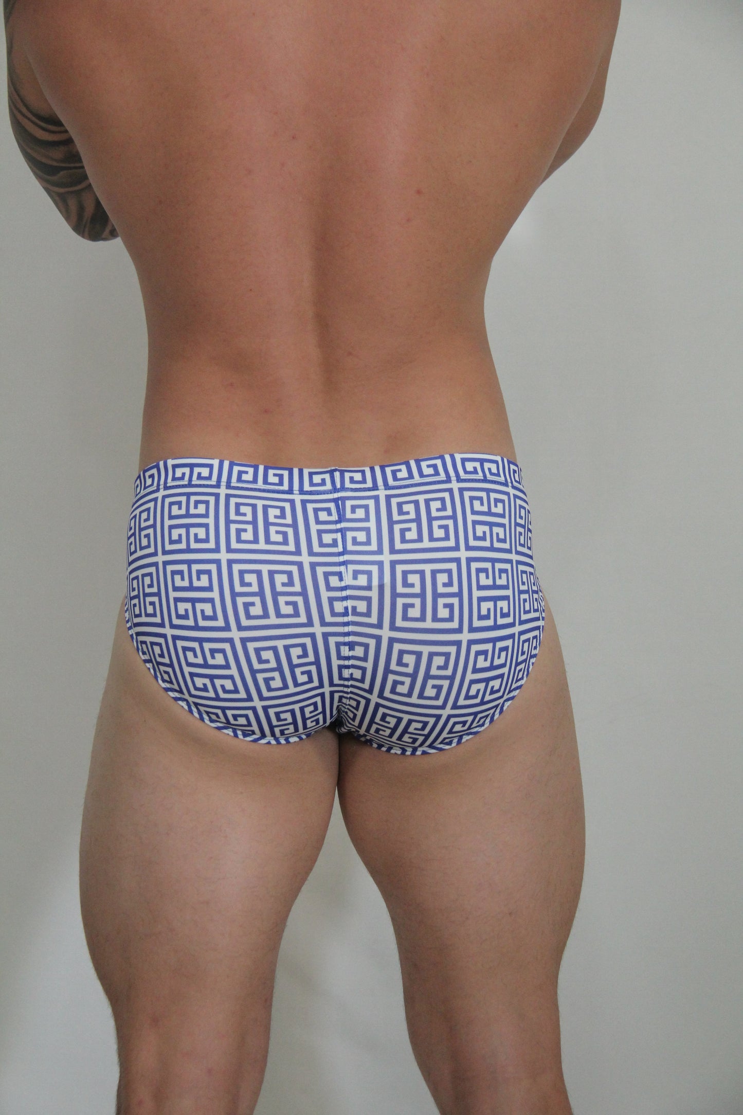 Designer print swim brief in blue and white featuring a repeating greek key pattern perfect for swimming