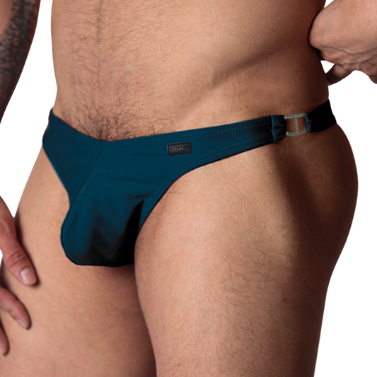 Gigo Dinamic green swim G-string, side view showing stretch fabric, metal side ring, and Gigo branding patch.