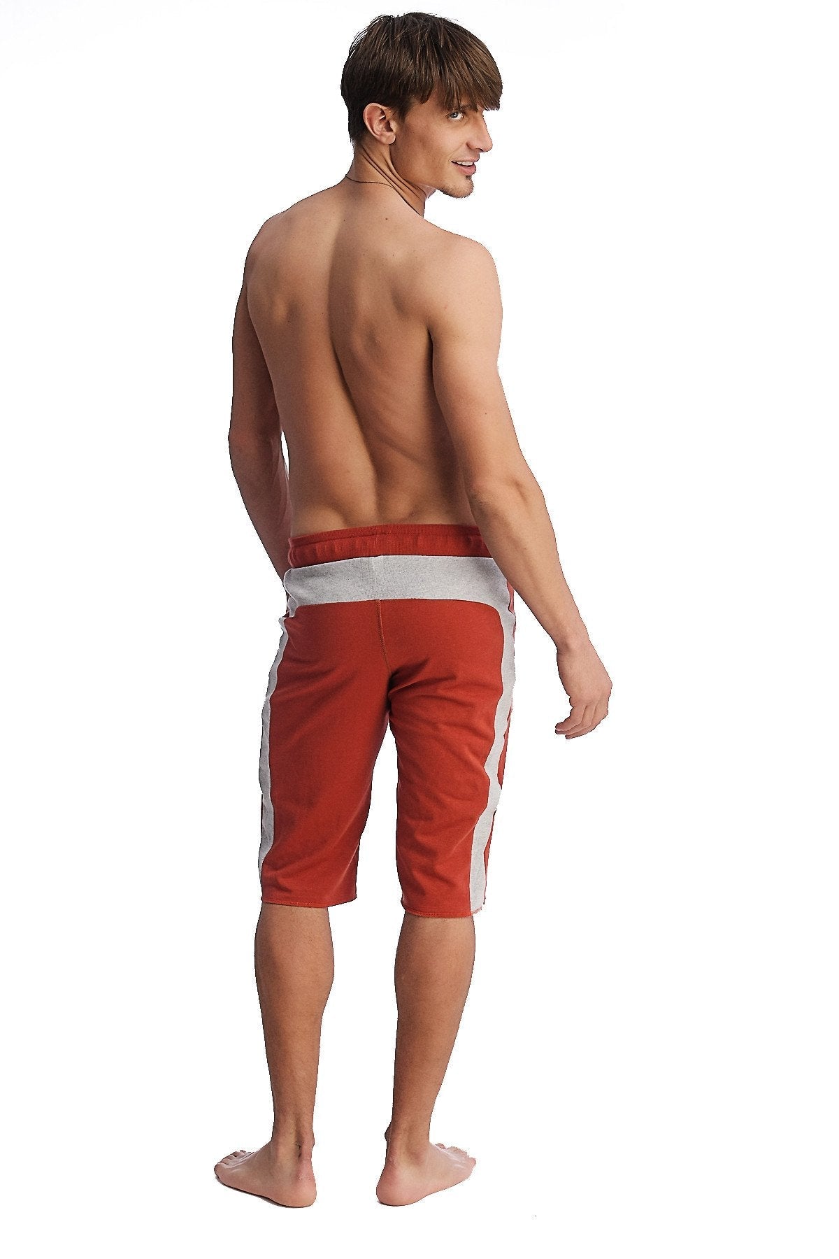 Eco-track short in cinnabar with grey waistband featuring red athletic shorts with white side stripes for active wear