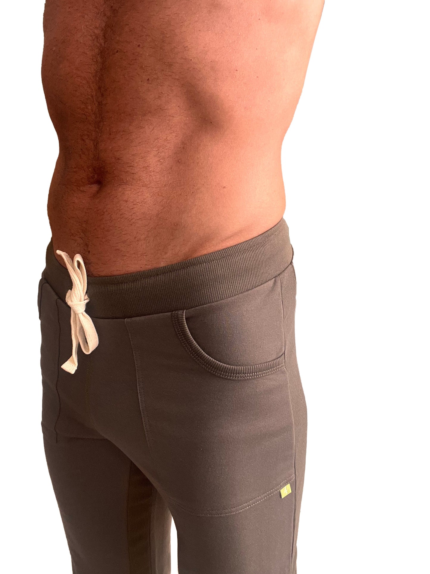 Brown eco-track and yoga sweat pant with ribbed elastic waistband and cream drawstring designed for athletic use