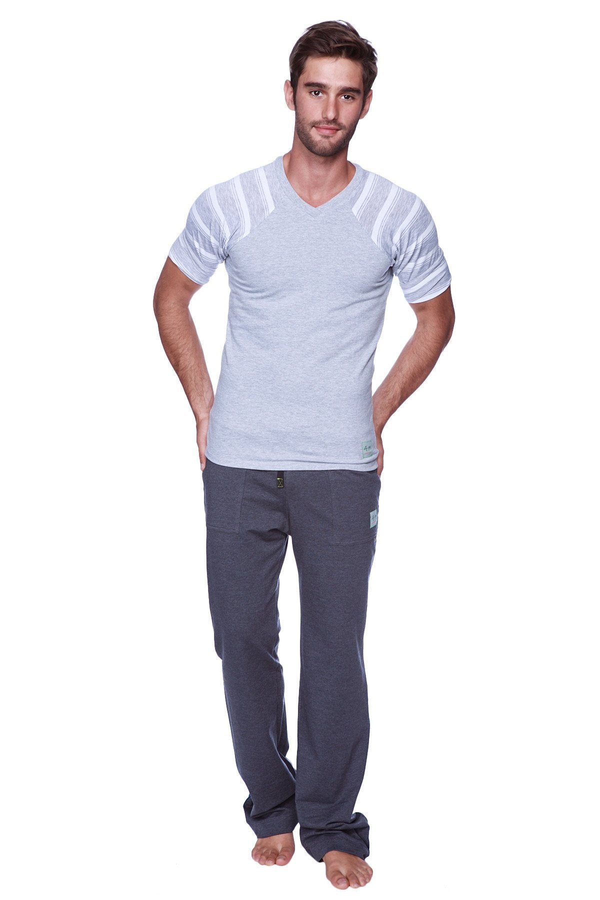 A man wearing eco-track and yoga sweat pant solid charcoal dark gray relaxed fit with light gray v-neck t-shirt