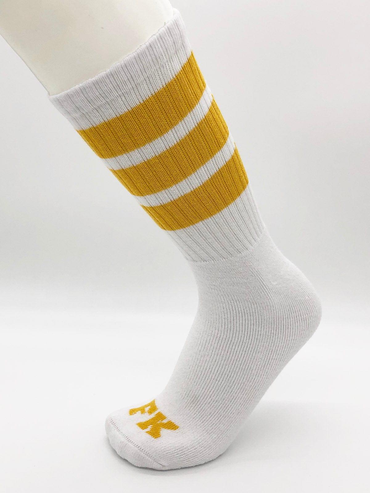 Fk sport white tube sock with three mustard-yellow stripes and small yellow logo on the toe in athletic style