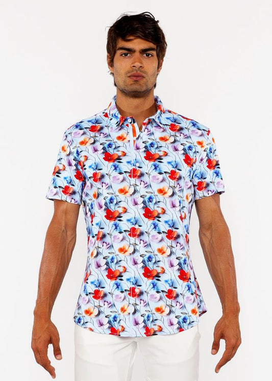 A white floral 3d print stretch knit shirt with bold red and blue blossoms and delicate pink accents