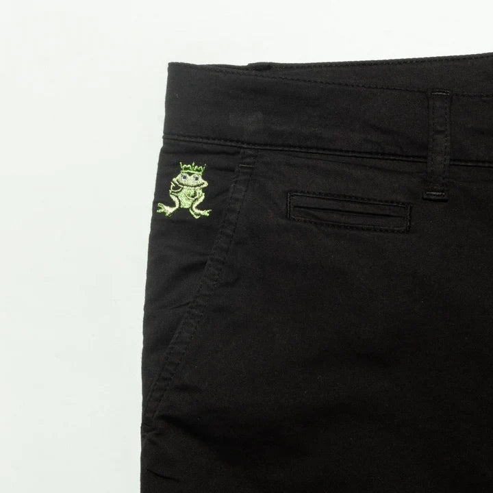 Back side of black denim frog chino short featuring an embroidered green frog with crown on the pocket
