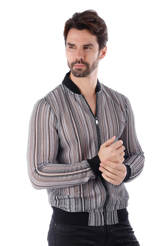 A man wearing a black and white striped funky novelty bomber jacket with ribbed cuffs and collar