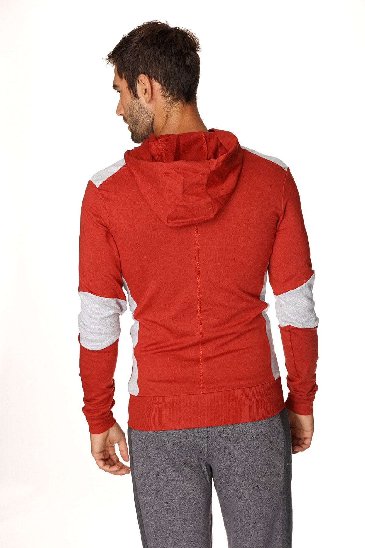 Form-fit crossover yoga track performance hoodie in cinnabar grey with red and white panels on shoulders sleeves and sides