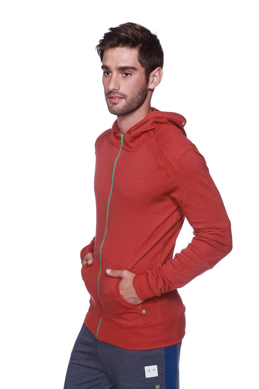 Form-fit crossover yoga track performance hoodie in solid cinnabar with green zipper trim and matching hood
