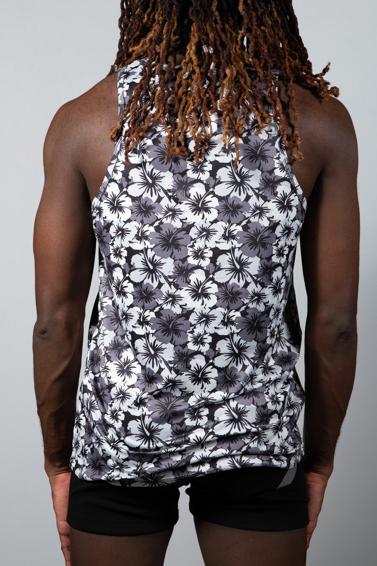 Hawaiian hibiscus print tank top with black and white floral design and fitted sleeveless style