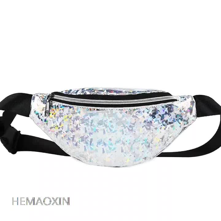 A holographic fanny pack with a shimmering material black zipper and adjustable strap for versatile wear