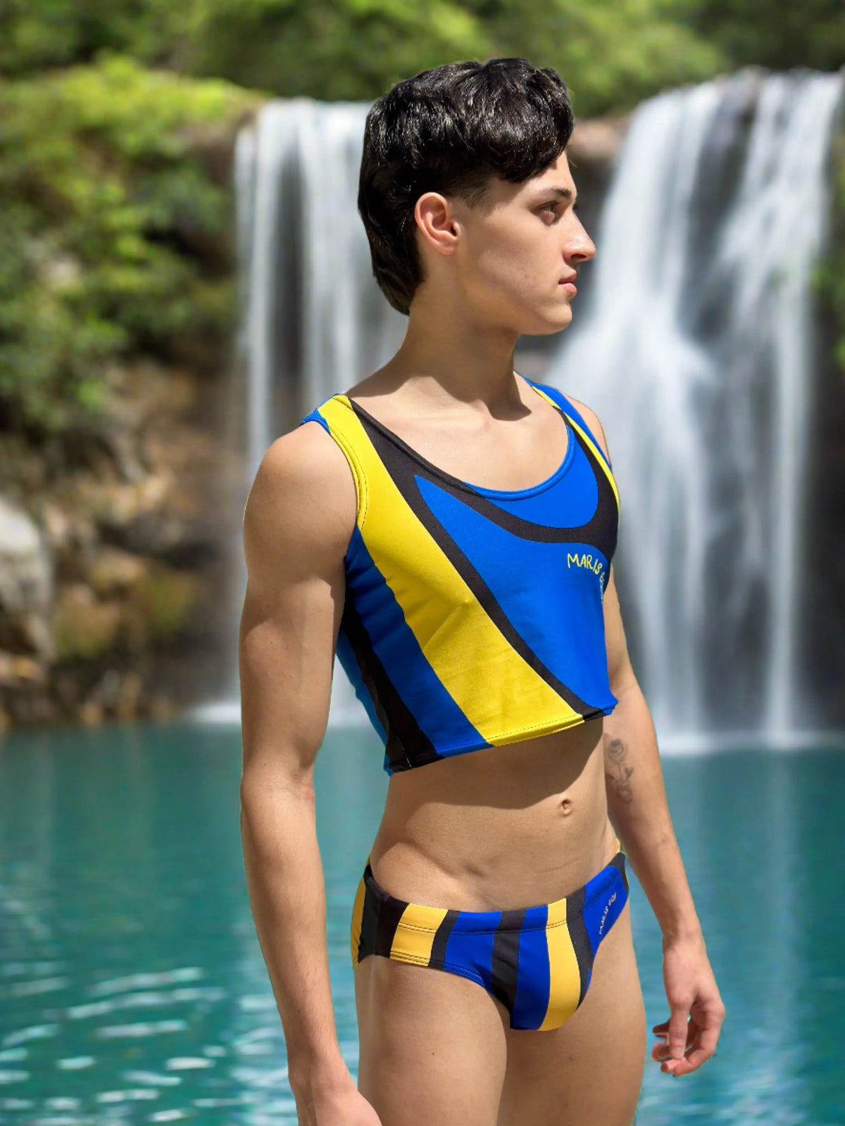 Men's swim briefs in blue and yellow with a matching crop top made by Maris Equi featuring a sporty design and fitted style.