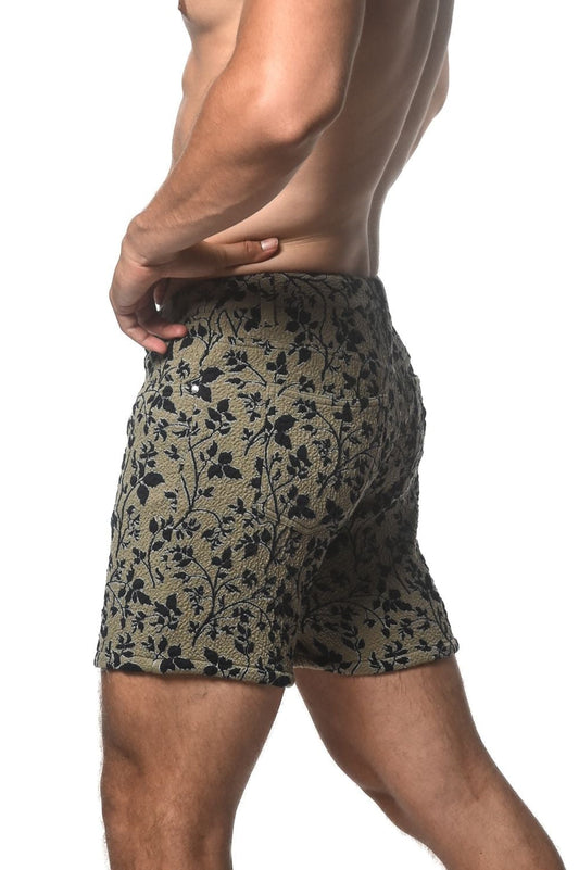 Olive green jacquard printed stretch knit shorts with black floral pattern and textured fabric
