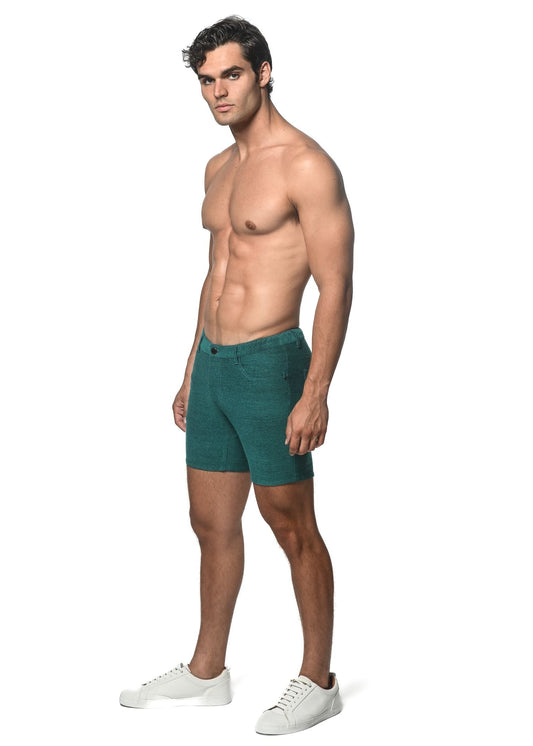 Teal loopback stretch knit slim-fit shorts made of textured fabric with visible stitching and belt loops