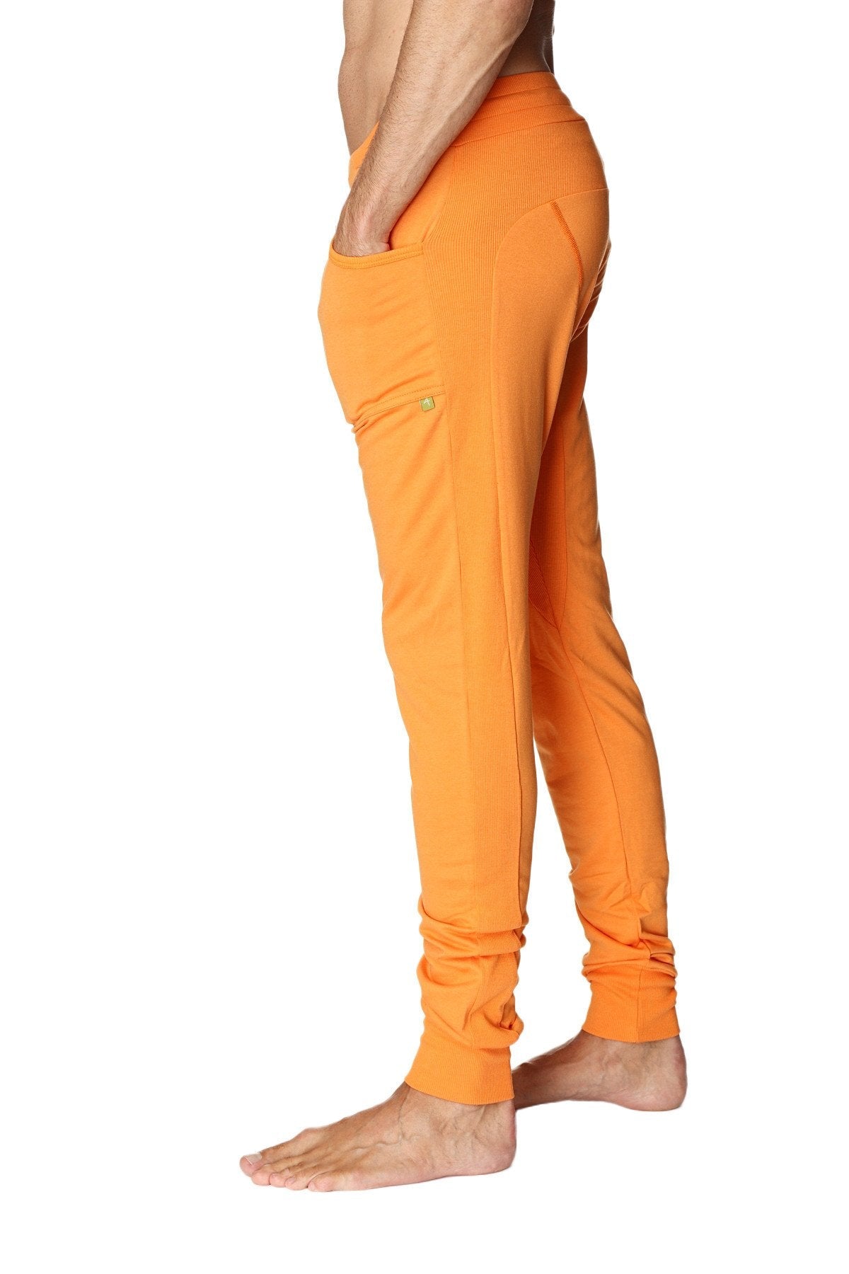 Long cuffed jogger and yoga sweat pants in sun orange with side pockets and relaxed fit for athletic use