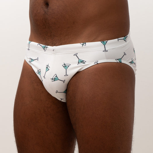 White swim brief featuring teal martini glass pattern with black outlines perfect for pool or beach wear