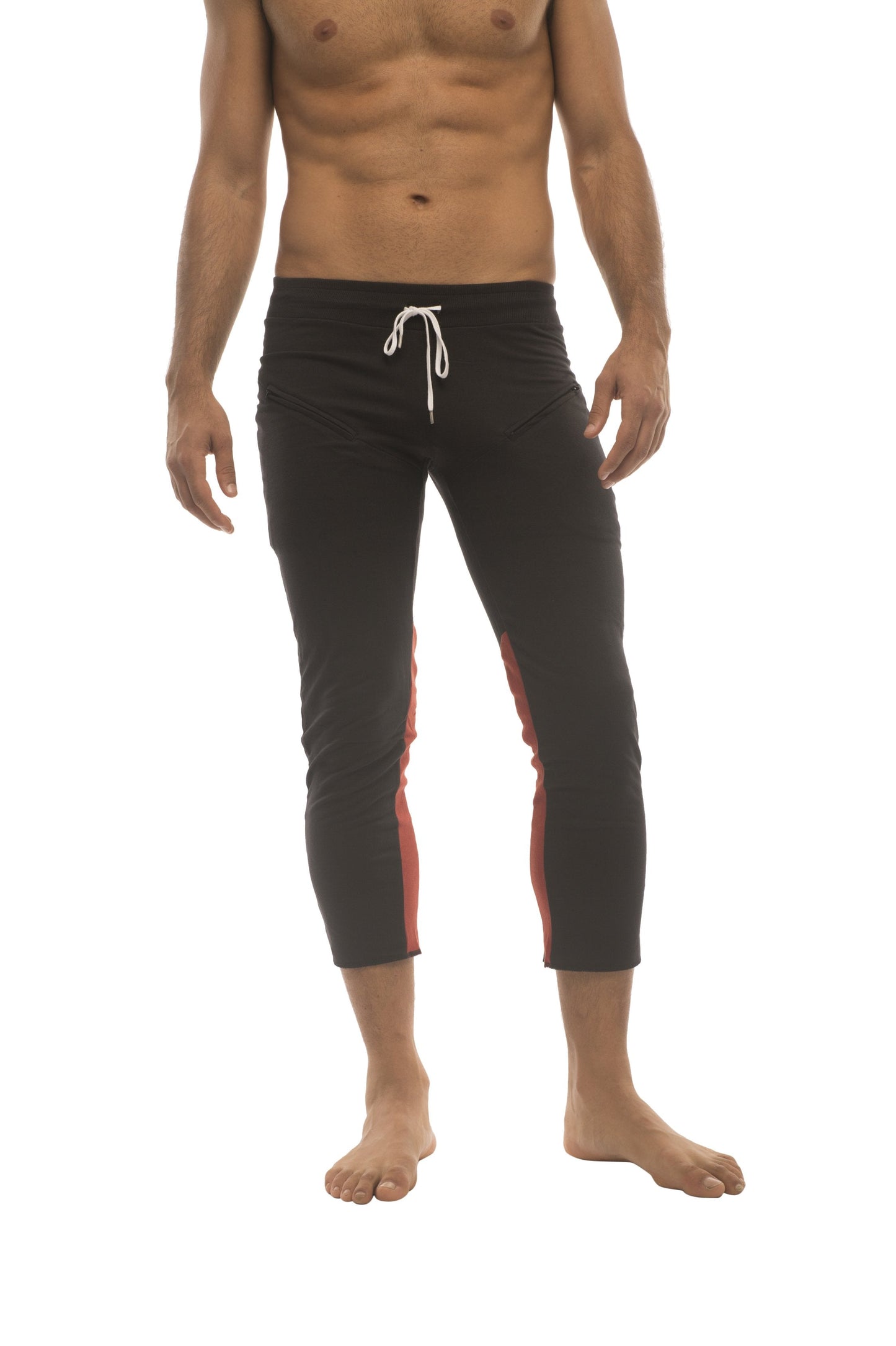 Mens black capri yoga pants with red side panels white drawstring waistband and 4/5 zipper pockets