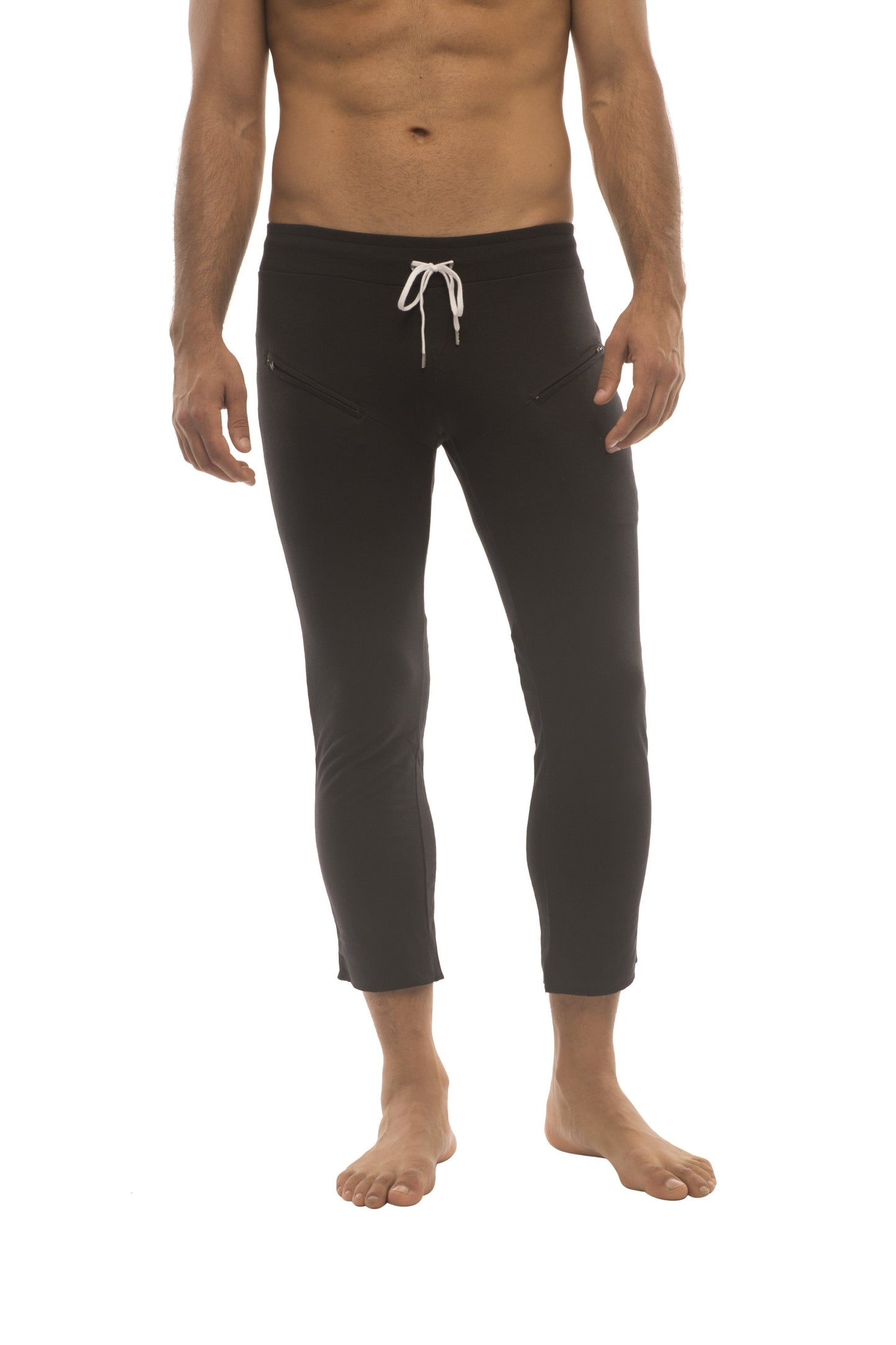Mens solid black capri yoga pants with zipper pockets and white drawstring waistband for comfortable wear