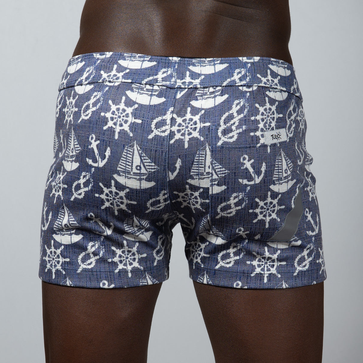 Nautical linen texture shorts in blue featuring white ship wheels anchors and sailboats pattern