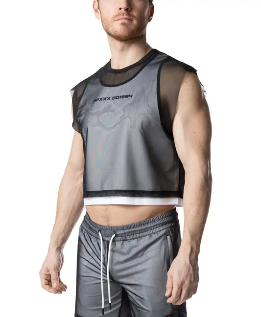 A black mesh crop top layered over a white tank top, featuring text on the chest, paired with grey drawstring shorts.
