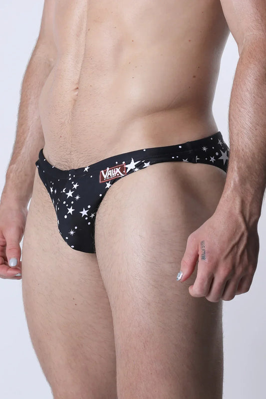 Pulse swim brief black swim trunks with white star patterns and red vaux logo on waistband front view