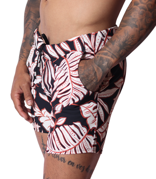 Gigo Prisma black and white leaf print beachwear shorts, side view showing drawstring waist and pocket detail.