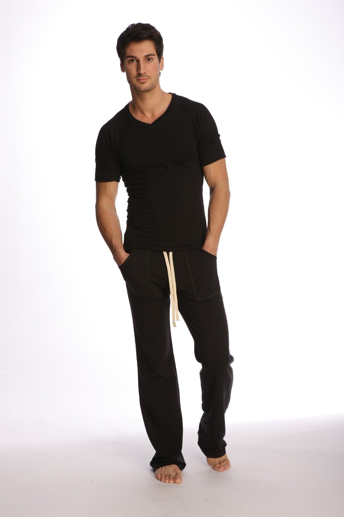 Black cotton joggers with cream-colored drawstrings paired with raglan virtual crew neck in black front view