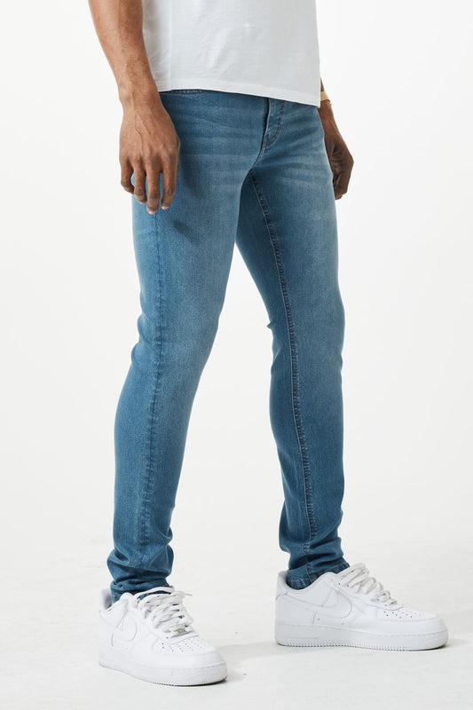 Blue skinny fit denim jeans with slim fit design five classic pockets and subtle fading on blue denim material