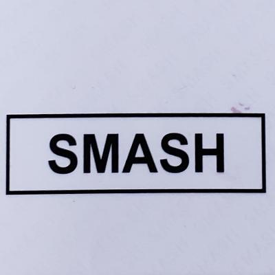 Black smash novelty top featuring a bold uppercase sticker with simple rectangular border design