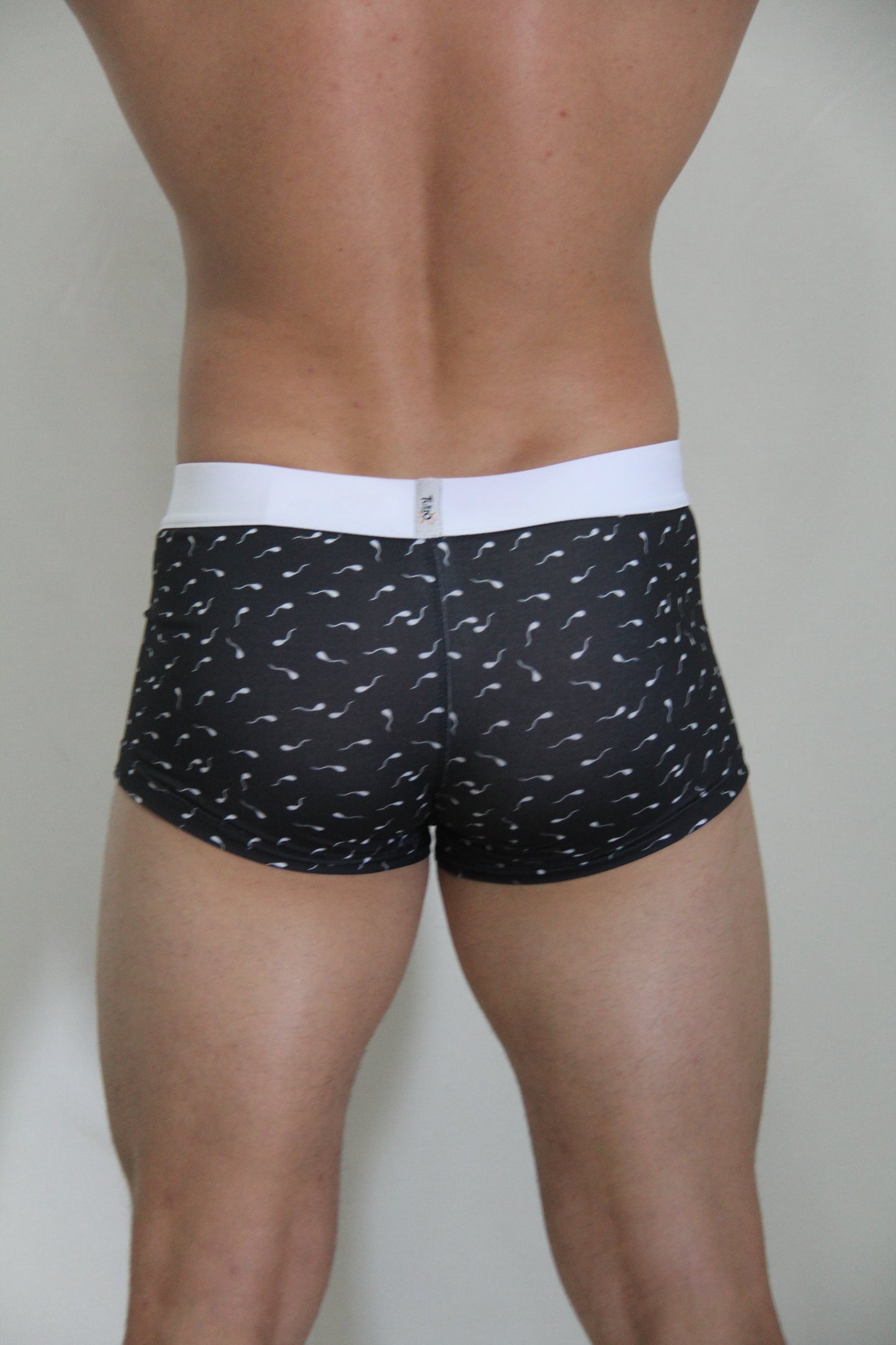 Black boxer briefs sperm trunk with white waistband and white stylized sperm pattern for casual wear