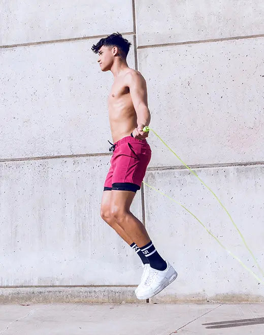 A vibrant red spr max short with black trim and drawstring waistband ideal for athletic use