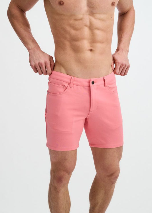 Crepe pink stretch knit shorts with belt loops, front pockets, and a button fly closure.