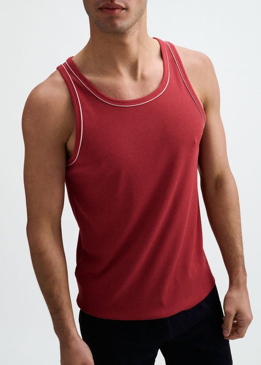 Carmine red ribbed tank top with white piping along the neckline and armholes.