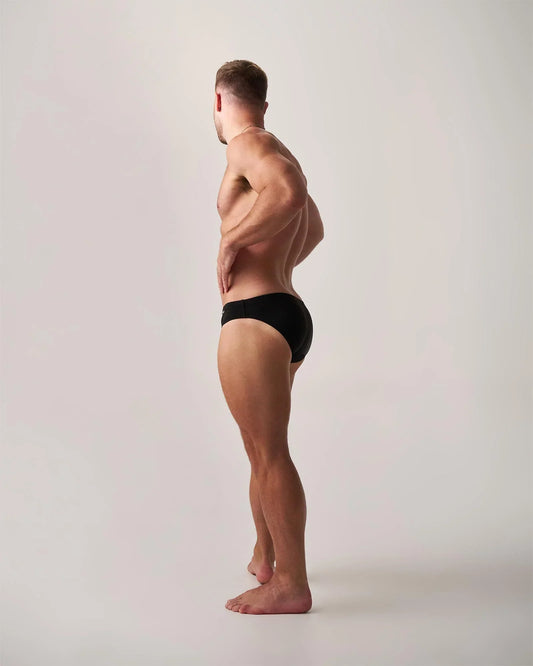 Black statement swim brief showing the back side made of quick-dry fabric ideal for swimming and beachwear