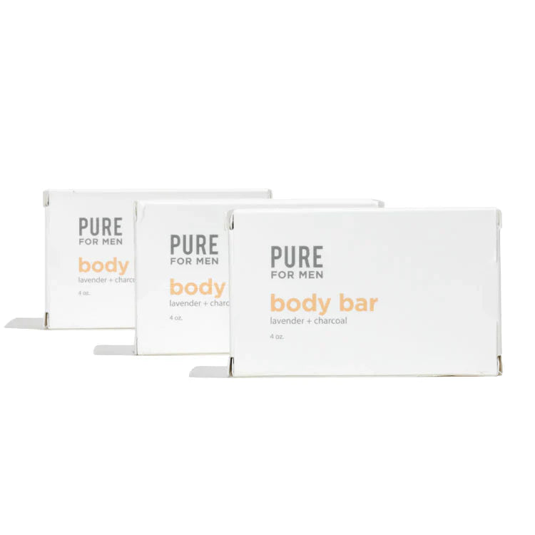 Three white rectangular boxes of pure for men lavender and charcoal body bar labeled stay ready bar in orange and gray text