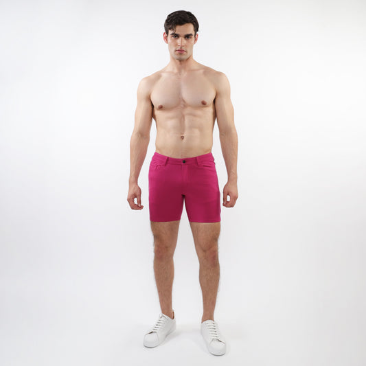 A pair of vibrant fuchsia stretch knit shorts with form-fitting modern design and subtle stitching details